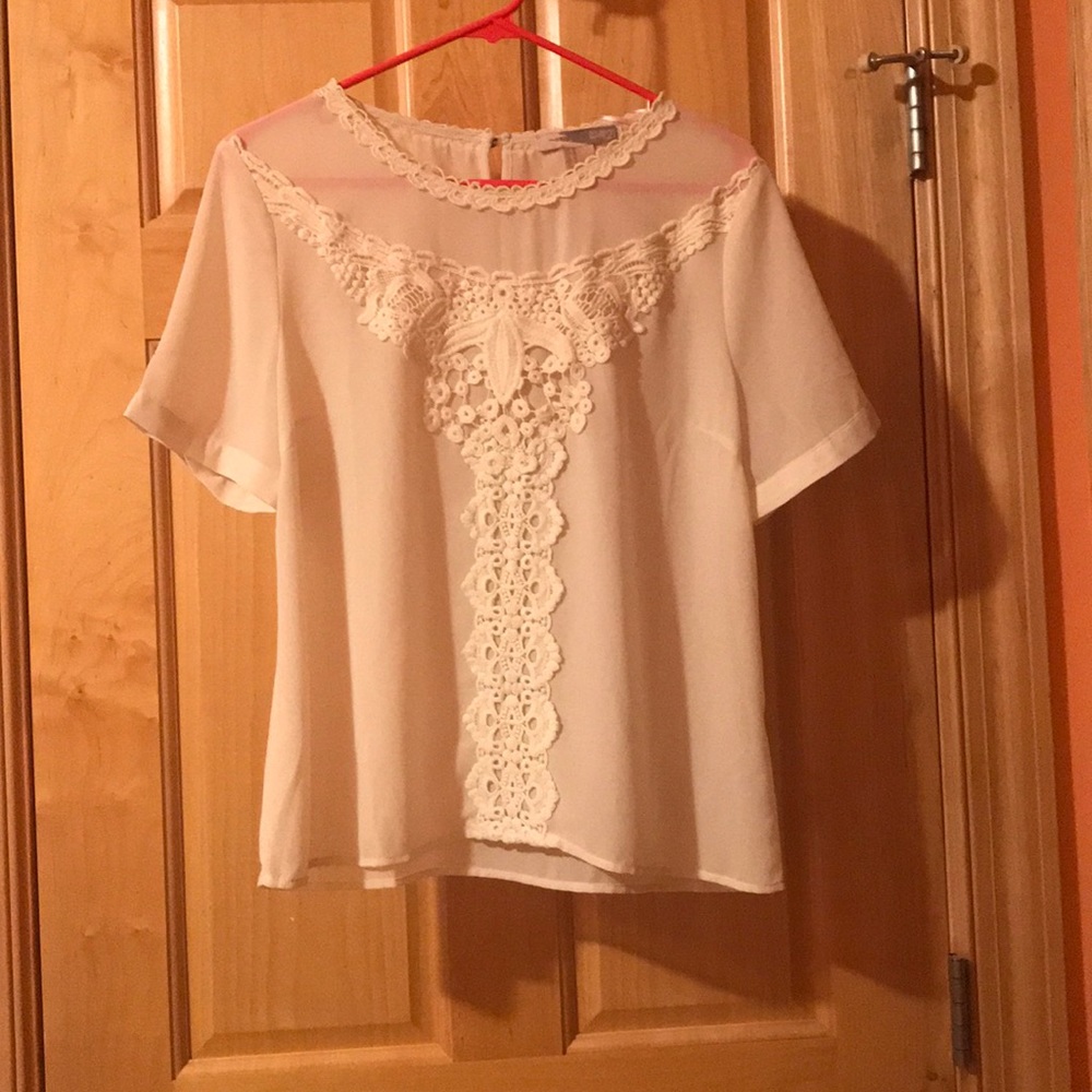 Cream colored blouse with embroidered detailing